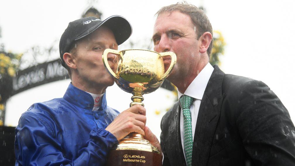 Sealed with a kiss: Charlie Appleby (right) and Kerrin McEvoy, the Melbourne Cup-winning trainer and jockey, savour the moment at Flemington