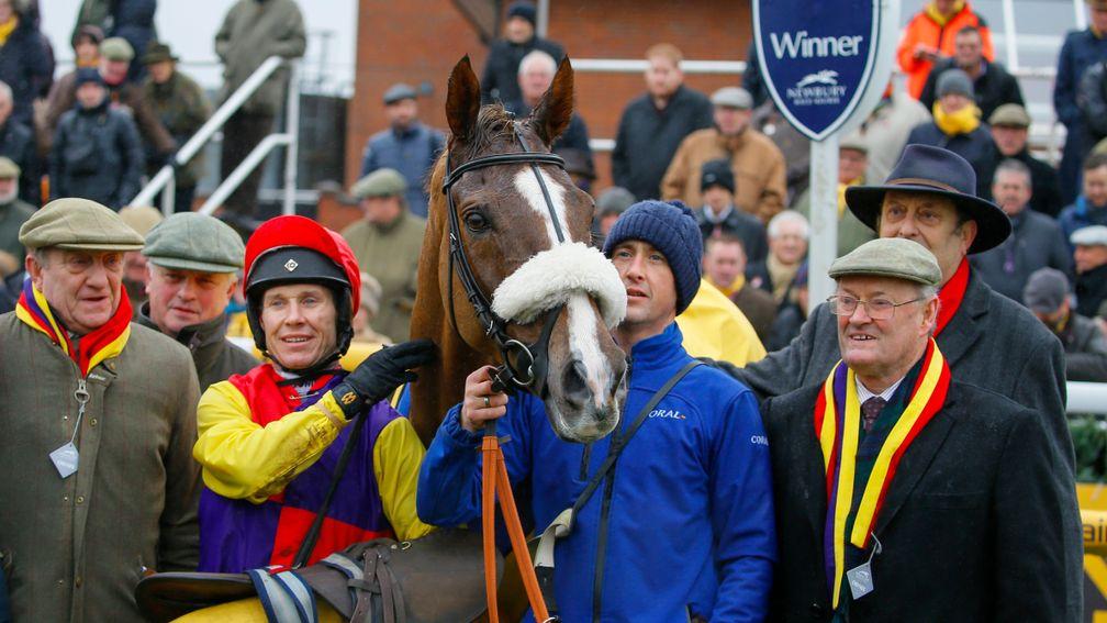 A relieved Native River team celebrate a repeat victory in the Betfair Denman Chase at Newbury on Saturday