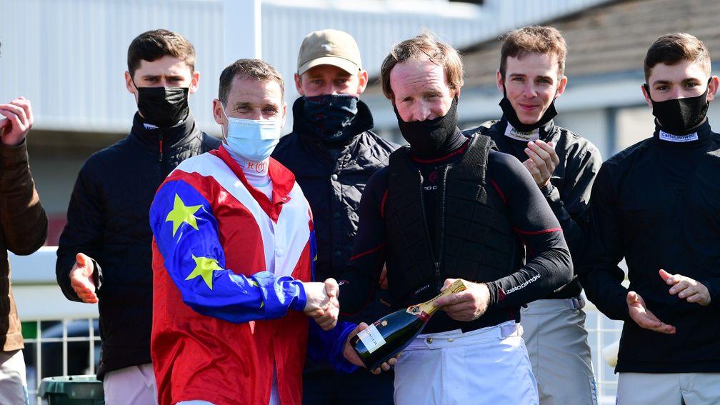 Richard Johnson presents fellow jockey Mark Grant with a bottle of champagne at Newton Abbot on Saturday before later announcing his own retirement