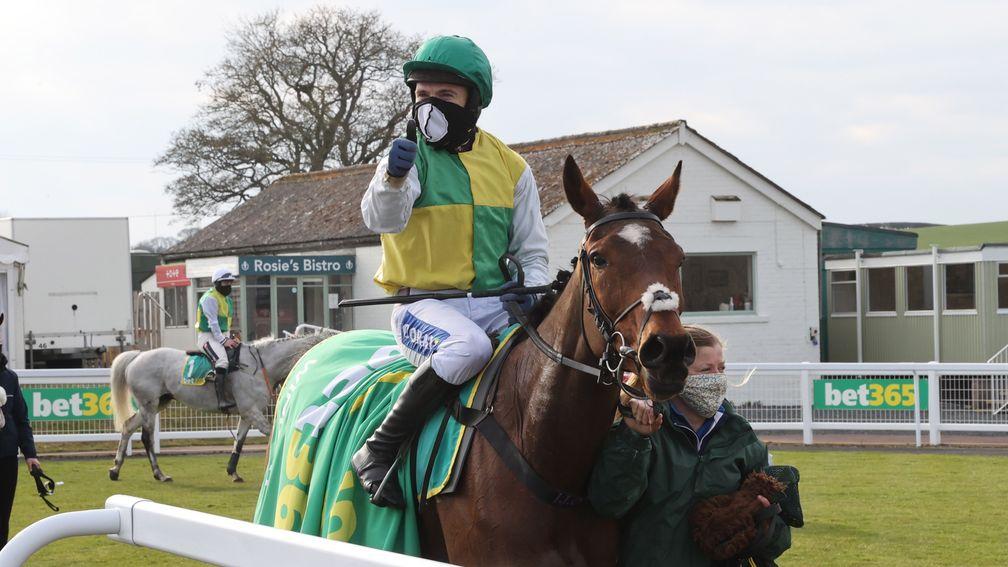 Tom Scudamore offers a thumbs up while being led in after Cloth Cap's Premier Chase win