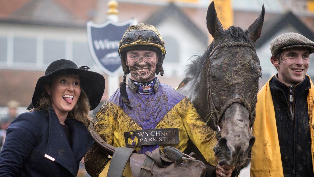 A filthy horse and rider pose for pictures alongside a delighted Amy Murphy in the winner's enclosure