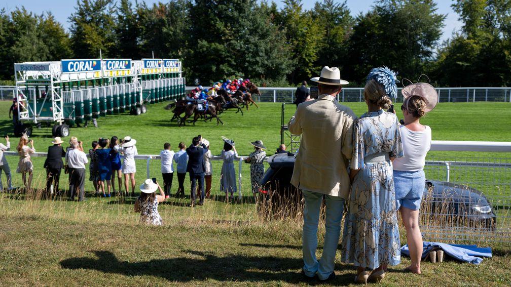 Racegoers watch the runners break from the stalls in the 6f handicapGoodwood 29.7.22 Pic: Edward Whitaker