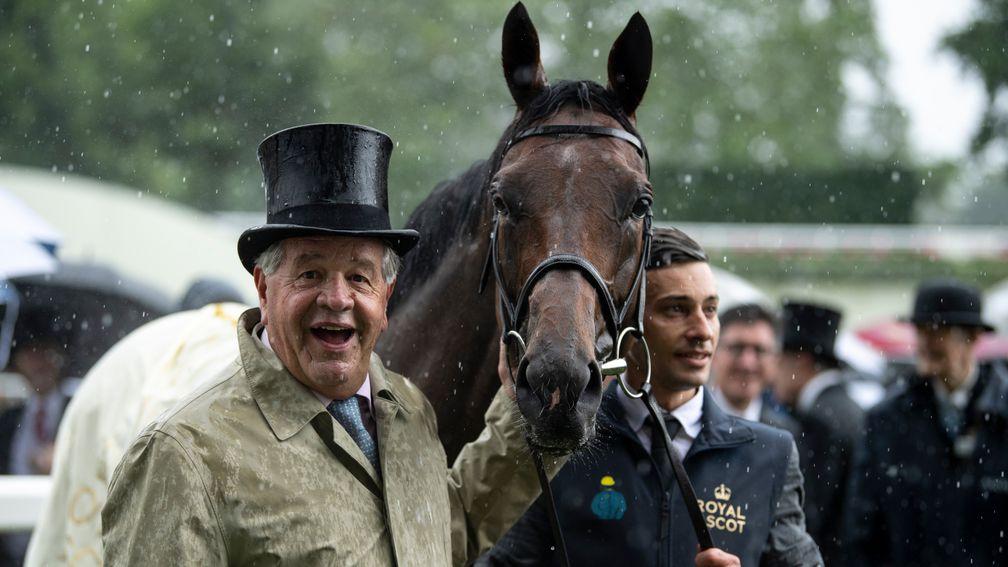 Sir Michael Stoute and Crystal Ocean in the rain after the Prince Of Wales's Stakes