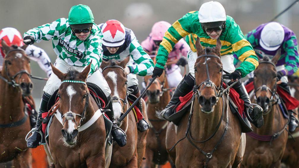 SUNBURY, ENGLAND - FEBRUARY 22: Nico de Boinville riding Downtown Getaway (L, green/white check) win The Betway Handicap Hurdle from Jonjo O'Neill Jr and Palmers Hill (green/gold hoops) at Kempton Park Racecourse on February 22, 2020 in Sunbury, England.