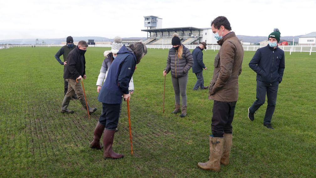 Jockeys, trainers and officials observe the course during the fourth inspection at Ffos Las