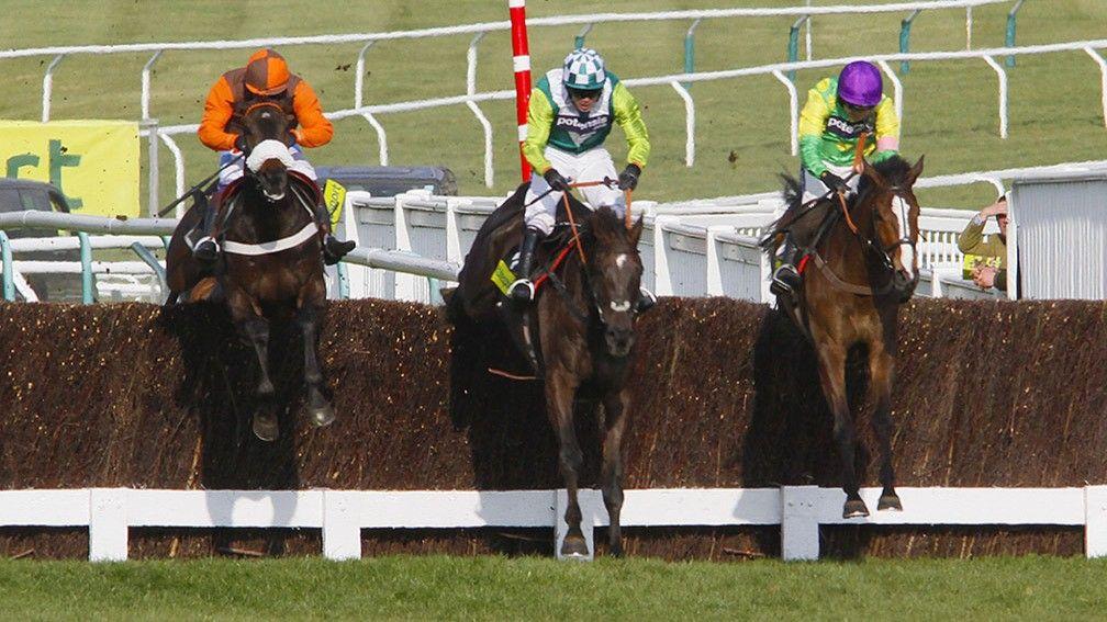 Denman (centre) fights for the 2011 Cheltenham Gold Cup with Long Run (left) and Kauto Star