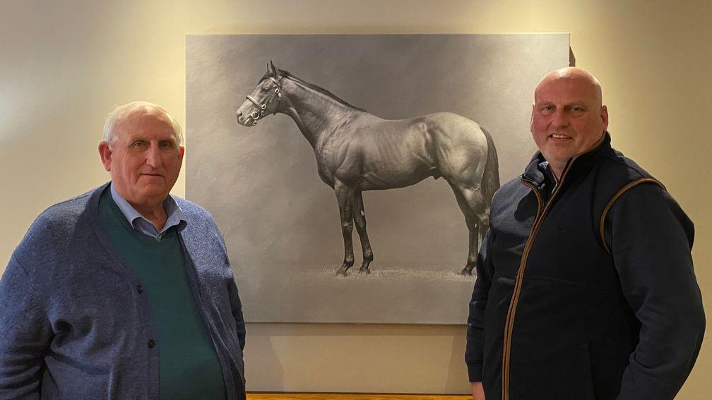 Peter and Simon Taplin in front of a picture of Sixties Icon
