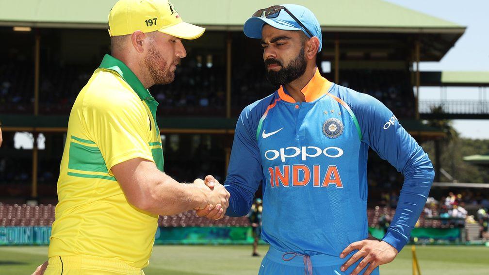 Virat Kohli (right) shakes hands with Australia captain Aaron Finch