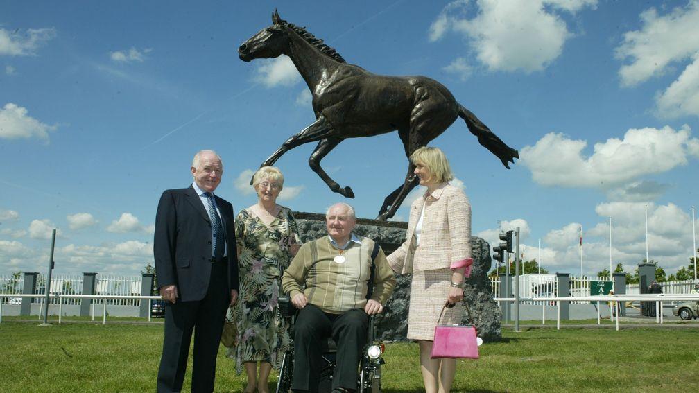 Sean and Anne Coughlan, left, pictured with sculptor Emma McDermott, and Johnny Carey, underneath the Ridgewood Pearl statue at the Curragh