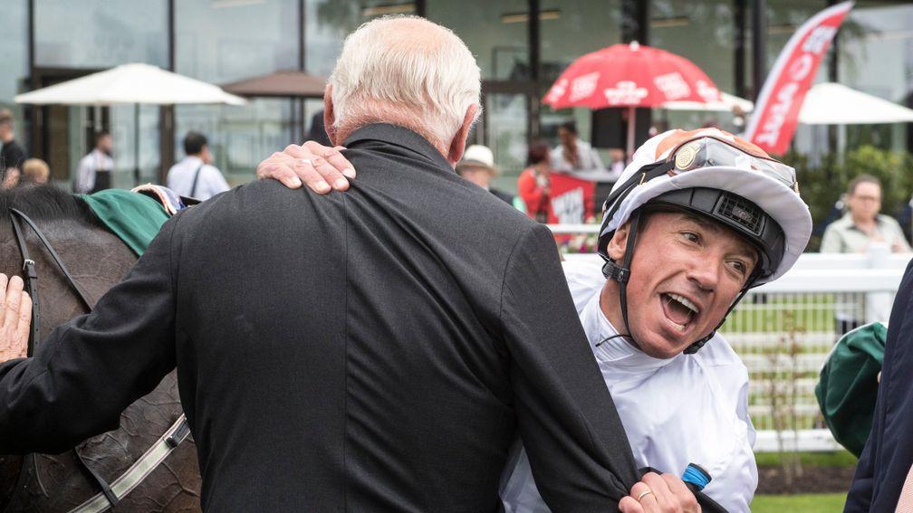 Frankie Dettori hugs Martyn Meade after victory for Advertise in the Phoenix Stakes
