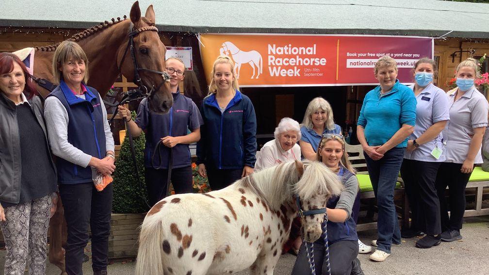 Sigurd poses for a photo with owner Liz Verity (far left), trainer Jo Foster (second left), shetland pony companion Teddy plus stable staff and residents and staff of Abbeydale care home