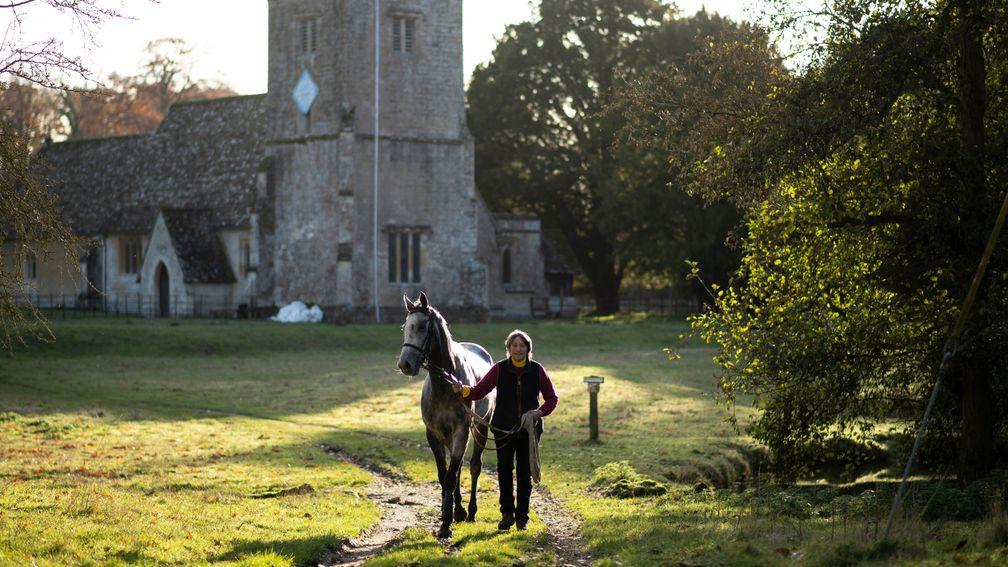 Henrietta Knight leads an unschooled horse of Nicky Hendersonâs called Buzz past the ancient Lockinge church  13.11.19 Pic: Edward Whitaker