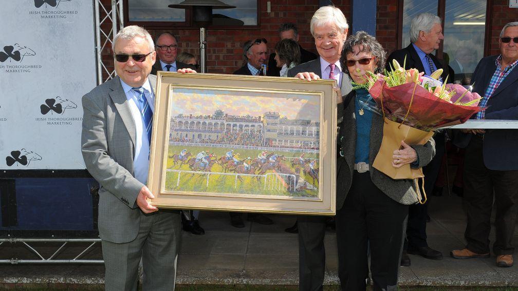 Bob Davies (left) and wife Dorcas receive a painting from Ludlow chairman William Jenks