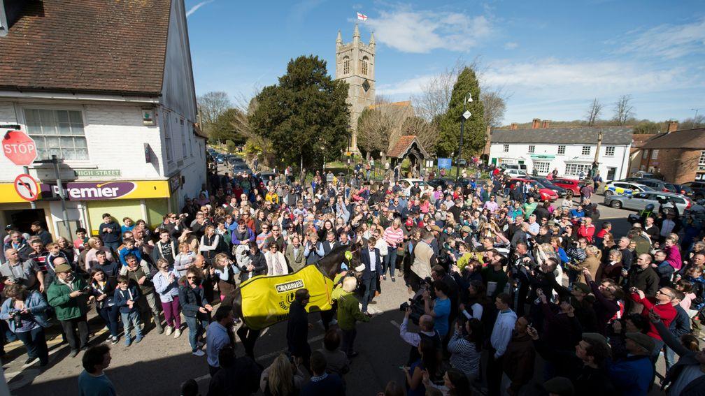 Many Clouds is greeted by hundreds of well wishers as he is led into the centre of Lambourn the day after winning the Grand National