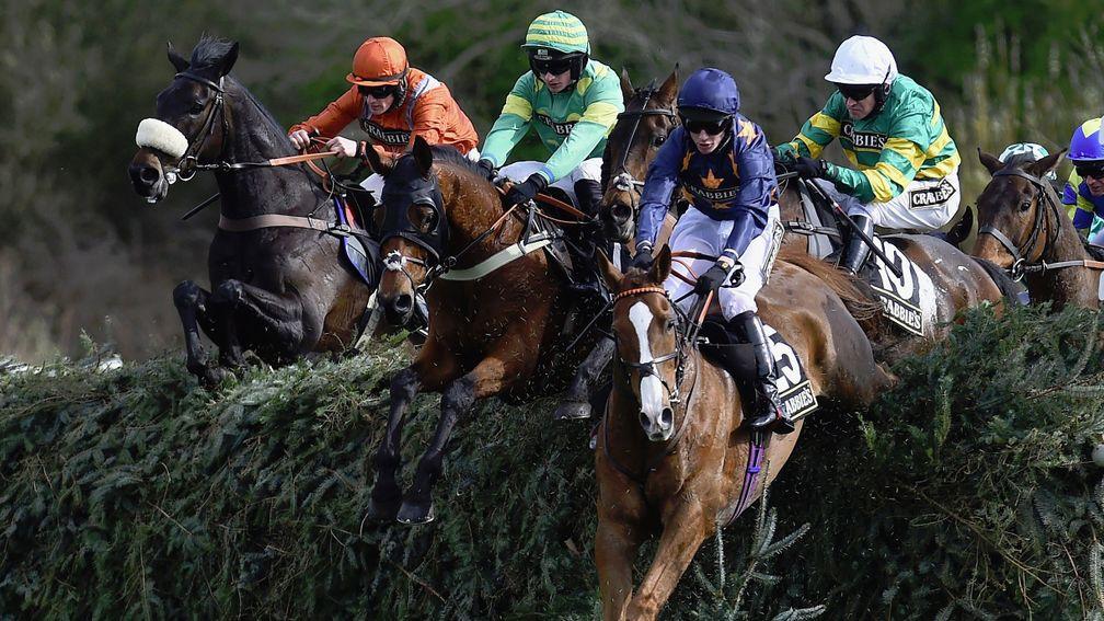 LIVERPOOL, ENGLAND - APRIL 08:  Eastlake (centre) ridden by Barry Geraghty jumps  Canal Turn behind leader Fairy Rath ridden by Tom Cannon during The Crabbies Topham Steeple Chase at Aintree Racecourse on April 8, 2016 in Liverpool, England.  (Photo by La