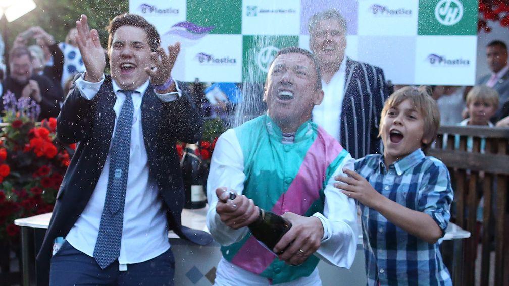 Dettori celebrates with his sons Leo (left) and Rocco after riding his 3000th winner on Predilection at Newmarket. His family has become an emotional anchor