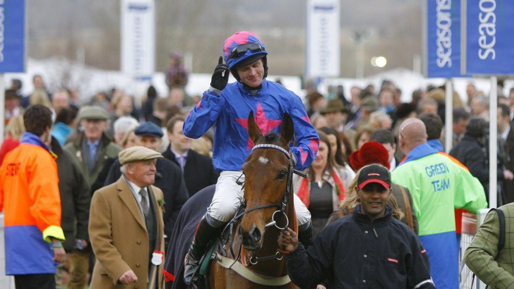 Cue Card and Joe Tizzard return to the winner's enclosure following their Champion Bumper victory