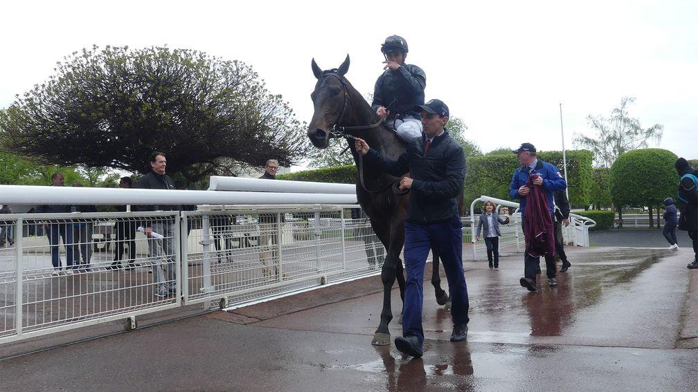 Christophe Soumillon and Greenland return to the winners' enclosure at a rainy Saint-Cloud 
