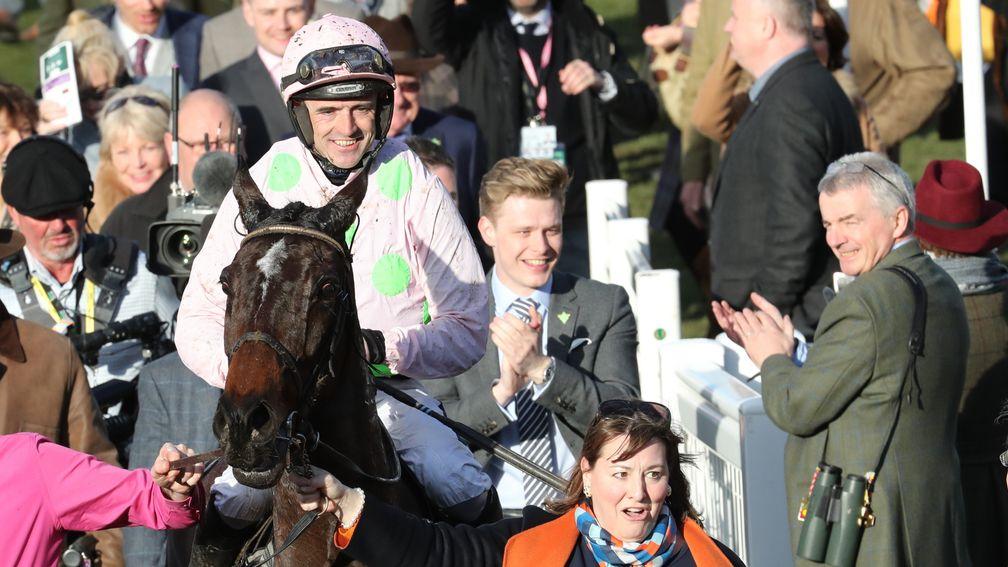 Ruby Walsh is led in after Benie Des Dieux landed the Mares' Hurdle