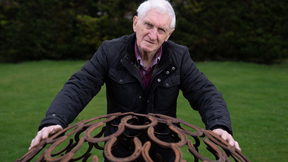  Martin Pipe in his garden with a sculpture made of horseshoes Nicholashayne 27.2.23 Pic: Edward Whitaker