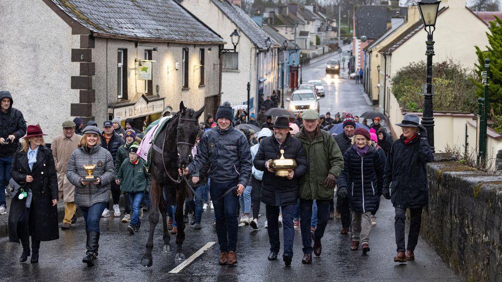 Owners Greg and Audrey Turley parade their Gold Cup trophies and Galopin Des Champs through the streets of Closutton
