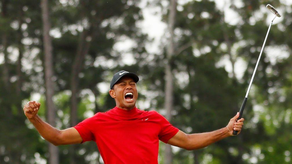 Tiger Woods celebrates after sinking his putt on the 18th green to win at Augusta for a fifth time