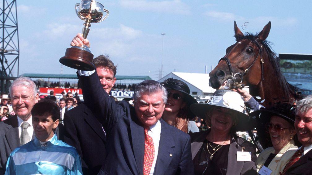 Bart Cummings holds aloft the Melbourne Cup after winning the race in 1999 with Rogan Josh