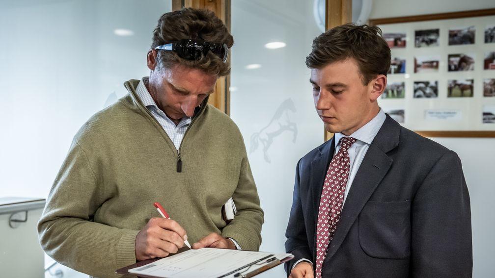 Tom Lacey signs on the dotted line after bidding £340,000 for bumper winner Mister Coffey
