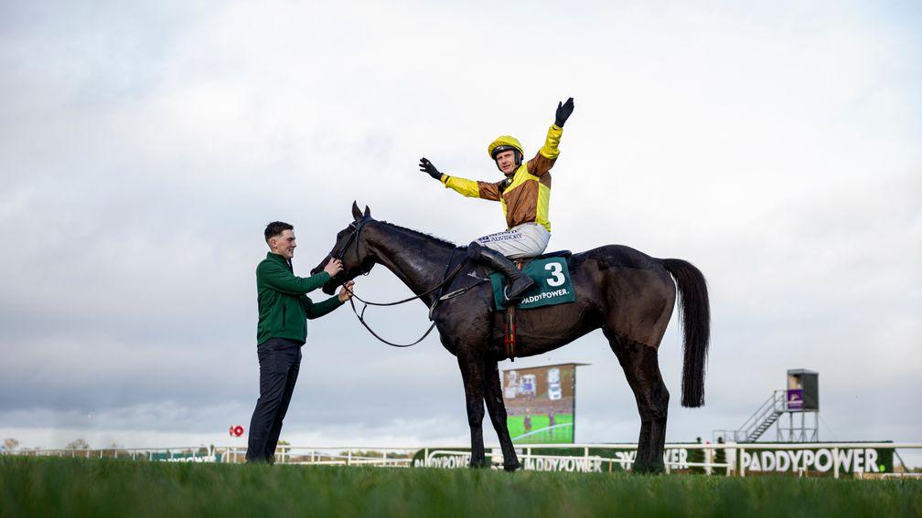 Paul Townend raises his arms in celebration after his first victory at the 2024 Dublin Racing Festival