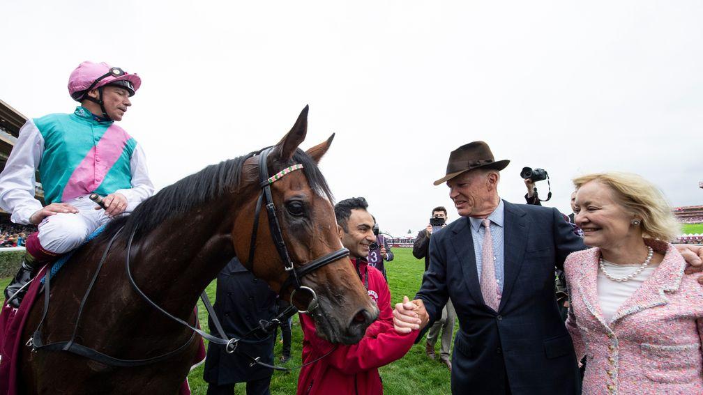 John Gosden shakes hands with Imran Shahwani, Enable's groom, after the filly's second Prix de l'Arc de Triomphe victory