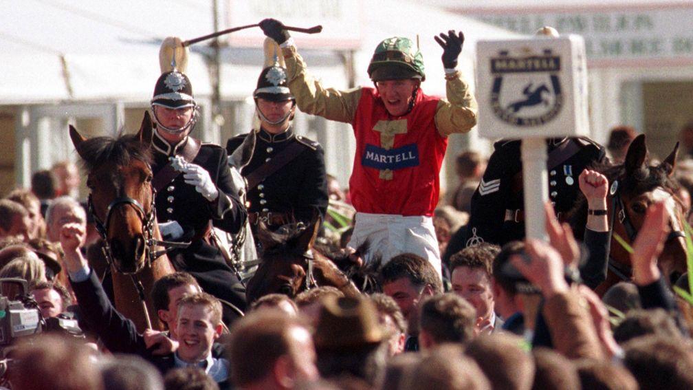 Paul Carberry celebrates his Grand National win on Bobbyjo on the return to the winner's enclosure