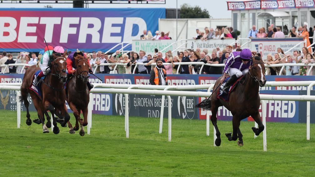 Arrest (left, pink cap) and Desert Hero chase Continuous home in the Betfred St Leger 