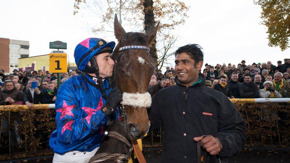 Paddy Brennan plants a kiss on Cue Card as groom Hamir Singh smiles in delight following the horse's victory in the 2016 Betfair Chase