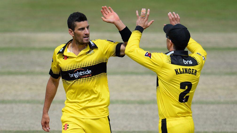 Benny Howell and Michael Klinger celebrate one of Howell’s four wickets against Kent