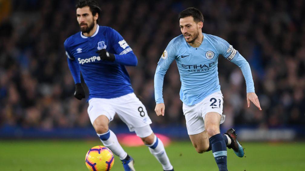Andre Gomes (left) of Everton pursued by David Silva