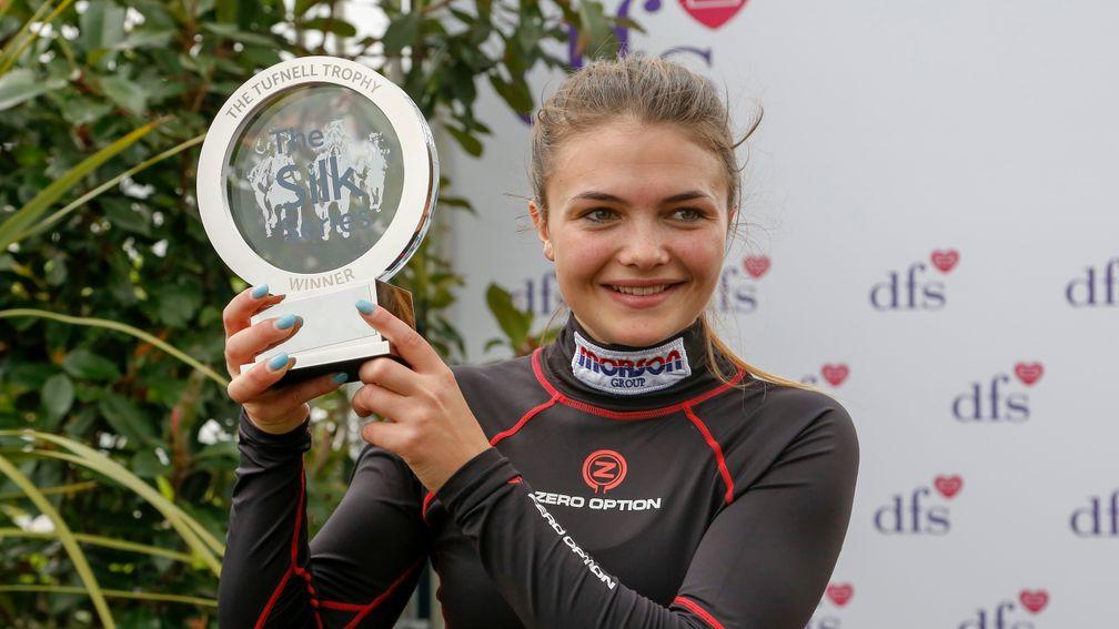 Megan Nicholls, displays her trophy as the overall winner of the Silk Series for female riders