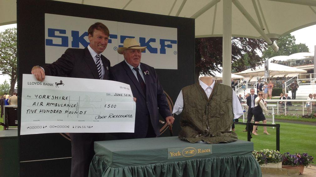 Mick Easterby is presented with a cheque for £500 in exchange for his jacket