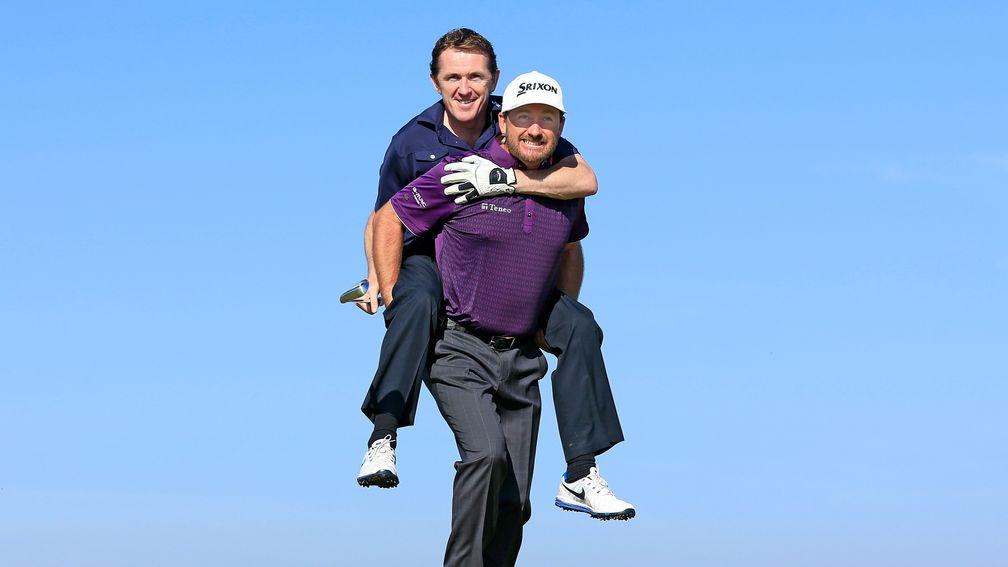 Sir Anthony McCoy is given a lift by playing partner Graeme McDowell
