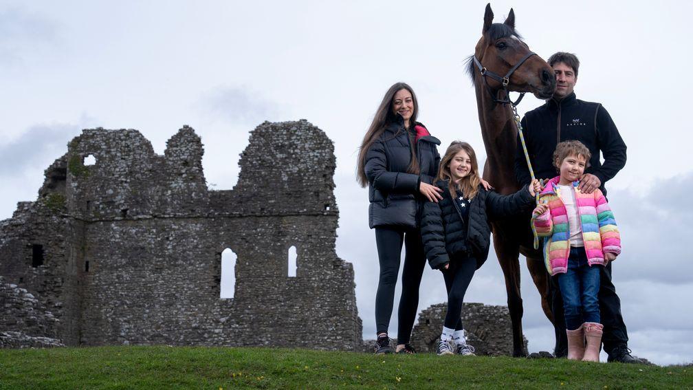 Christian Williams with  6yo daughter Betsy and his partner Charlotte with their elder daughter Tilly  (8) and Kitty's Light by Ogmore Castle at the foot of their racing yard  Ogmore Farm near Bridgend 2.4.24 Pic: Edward Whitaker