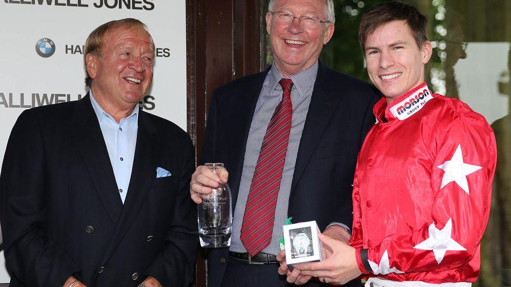 Francis Lee presents Sir Alex Ferguson and Richard Kingscote a winning prize at Haydock in 2014