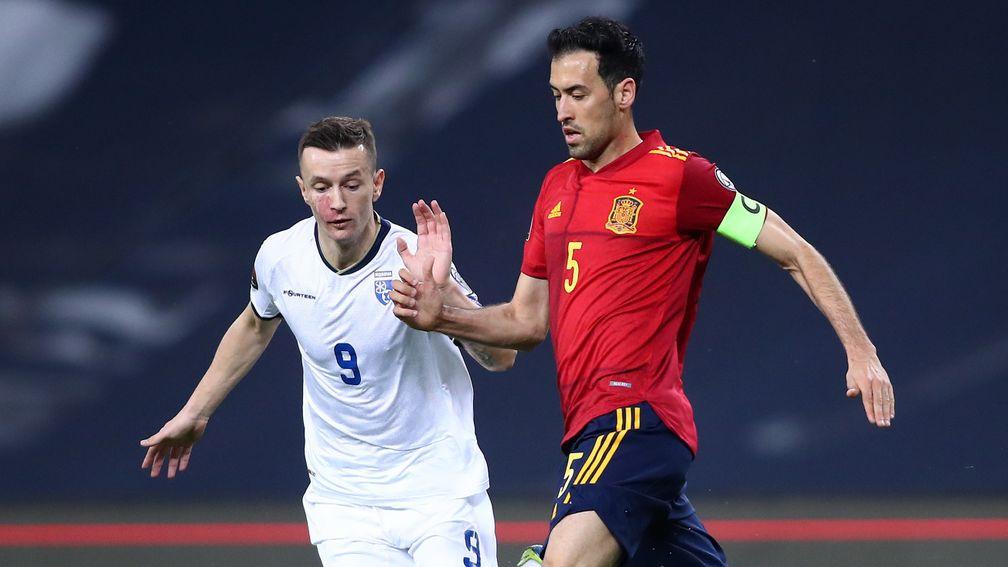 Deep-lying playmaker Sergio Busquets (right) is a key figure in Spain's midfield