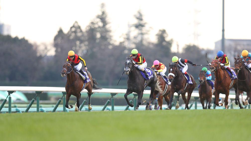 Chrono Genesis (second left) comes with her winning charge in the Arima Kinen
