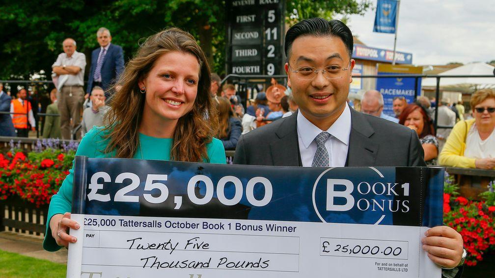 Johnny Hon collects his Book 1 Bonus cheque from Melissa Jordan of Tattersalls