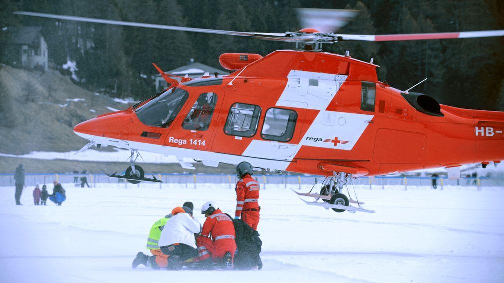Medics prepare George Baker for airlifting from the frozen lake at St Moritz following his fall from Boomerang Bob