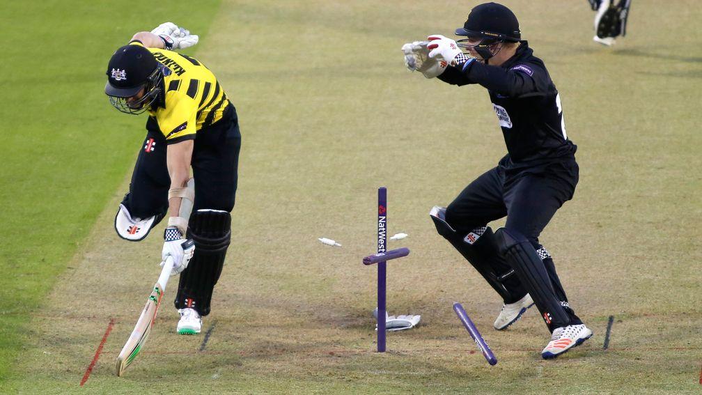 Sussex wicketkeeper Ben Brown tries to run out Michael Klinger of Gloucestershire